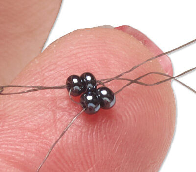 Four beads on thread